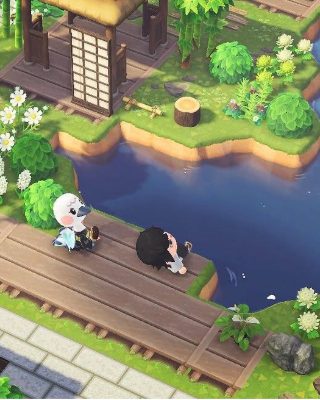 An Animal Crossing island: a villager on a wooden boardwalk beside a river, cherry trees and a shrine behind.