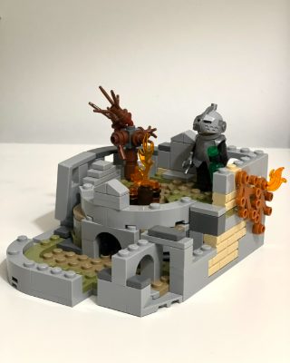 A Lego model of the Firelink Shrine from Dark Souls, with a coiled-sword bonfire and a knight figure.